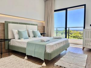 a bedroom with a large bed with a large window at Villa Ulysse 4 Bedroom Private Pool in Hammamet +36 photos
