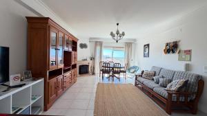 a living room with a couch and a table at Sunset Hideaway Santa Cruz in Silveira