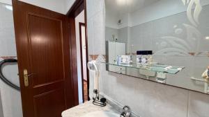 a bathroom with a sink and a mirror at Sunset Hideaway Santa Cruz in Silveira +23 photos