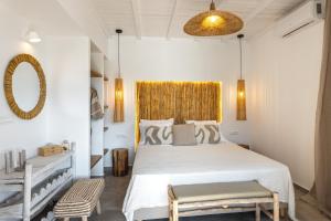 a bedroom with a white bed and a yellow window at Theasea luxury retreat in Vrachonisída touArchangélou