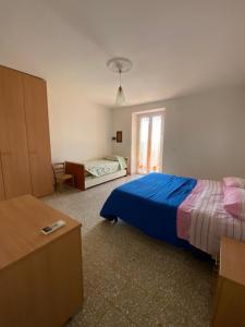 a bedroom with a blue bed and a window at Il Casale di Nonna Bambina in Francavilla al Mare