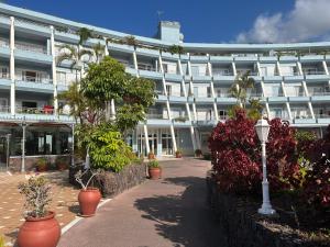 a large white building with plants in front of it at MC La Quinta in Santa Úrsula