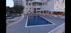 a swimming pool in front of a building at SUL MARE... in Misano Adriatico