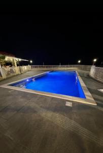 a large blue swimming pool at night at SUL MARE... in Misano Adriatico +10 photos