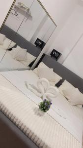 a bedroom with a bed with towels and a mirror at Cozy unit in mivesa garden residence in Cebu City +6 photos