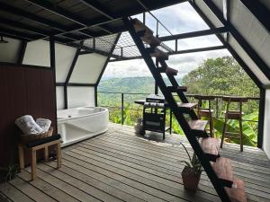a bathroom with a bath tub and a staircase to a deck at Saray glamping in Palestina