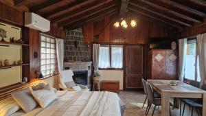 a bedroom with a bed and a table and a fireplace at Monolocali In Casa Con Giardino Bellagio in Bellagio