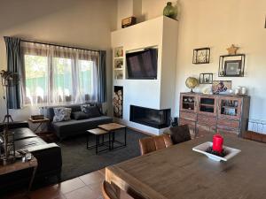 a living room with a couch and a table at Can Roura in Rocabruna