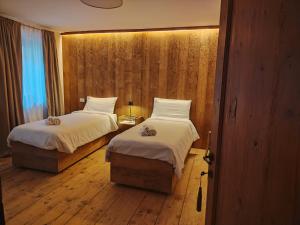 a hotel room with two beds and a window at La Casa dei Ricordi in Igne +8 photos