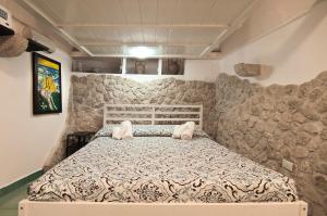 a bedroom with a large bed in a room at Casa Vacanza La Giosa in Sperlonga