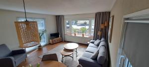 a living room with a couch and a table at Comfortable Chalet in Berkhout