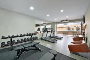 a gym with several treadmills and machines in a room at O2 Grand Suvarnabhumi Airport - Free Scheduled Shuttle from Hotel to Suvarnabhumi Airport in Bang Phli