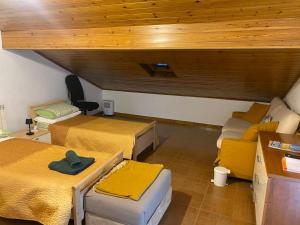 a room with two beds and a couch at Matì 2 con navetta 25Eur in Lonate Pozzolo