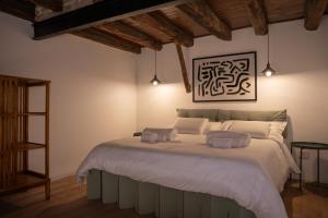 a bedroom with a large bed with two towels on it at Casa Martù in Palermo