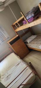 two bunk beds in a room with another bed at - Apê perto do Alphaville - in Osasco