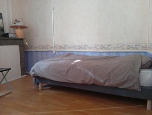 a bedroom with a bed with a blue head board at Les Lavandières in Satillieu