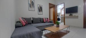 a living room with a gray couch and a table at Andre House in Mesimvría