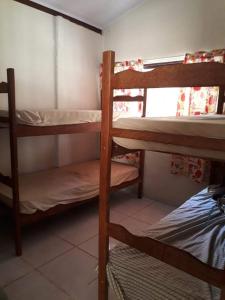 a room with two bunk beds and a window at Sossego e Lazer na Serra do Cipó, piscina e Rio in Jaboticatubas +4 photos