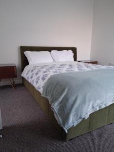 a bedroom with a large bed with white sheets and pillows at Morecambes wise place in Morecambe