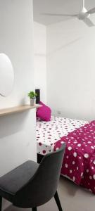 a bedroom with a bed and a chair and a desk at arin syah homestay in Jasin