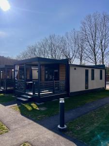 a mobile home with a canopy on the grass at Camping Resort Riegersburg in Riegersburg