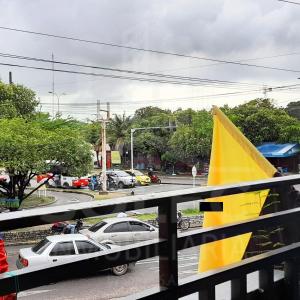 a yellow and white boat on a street with cars at Hospedaje Chavela in Barrancabermeja