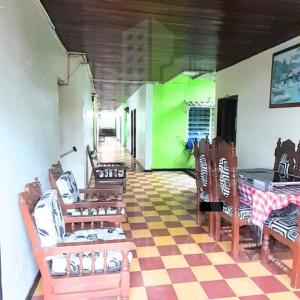 a room with chairs and a table with a checkered floor at Hospedaje Chavela in Barrancabermeja