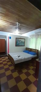 a bedroom with a bed and a ceiling at Hospedaje Chavela in Barrancabermeja