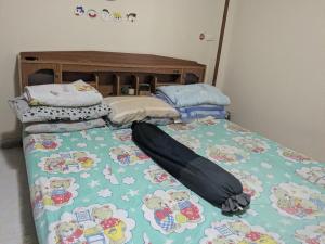 a bed with hello kitty sheets on top of it at Chez ma mère Homestay in Ko Chetmun