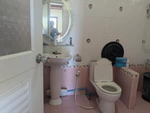 a bathroom with a toilet and a sink and a mirror at Chez ma mère Homestay in Ko Chetmun +40 photos