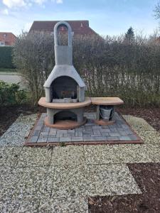 a pizza oven sitting on top of a patio at Meine Kaptän-Kajüte in Neßmersiel
