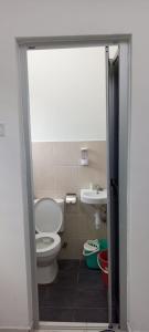a bathroom with a toilet and a sink at arin syah homestay in Jasin