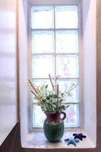 a vase sitting on a table in front of a window at EMELIAS HOUSE SEA SIDE in Naxos Chora