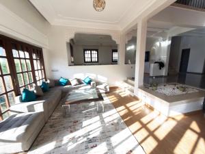 a living room with a couch and a table at Spacious villa in Founty, beach side 40m front Sofitel in Agadir +71 photos