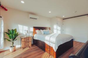 a bedroom with a large bed and a potted plant at American Hall - Kaufman Suite in Millersburg
