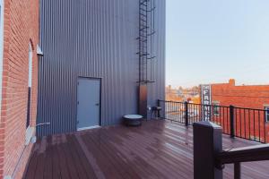 a balcony with a door on the side of a building at American Hall - Kaufman Suite in Millersburg