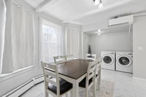 a kitchen with a table and chairs and a washing machine at Home In Highland Park in Saint Paul