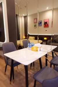 a white table with blue chairs and a mirror at ICON40 Homestay Hạ Long - Ocean View in Ha Long +93 photos