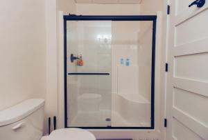 a shower with a glass door in a bathroom at American Hall - Hamilton Suite in Millersburg +31 photos