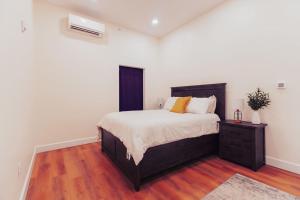 a bedroom with a bed and a dresser in it at American Hall - Hamilton Suite in Millersburg