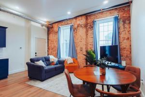 a living room with a table and a couch at American Hall - Young Suite in Millersburg