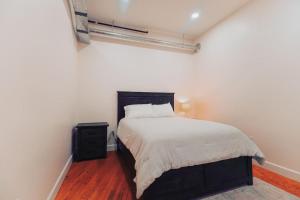 a bedroom with a bed with a black headboard at American Hall - Young Suite in Millersburg