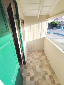 an empty room with a door and a tiled floor at Mage B&B 1 in Roseau