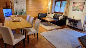 a living room with a table and a couch at Haus Strobler in Going am Wilden Kaiser