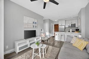 a living room with a couch and a kitchen at Lake Simcoe Stays - Friday Harbour's Official Rental Program - Scyamore Suite in Innisfil