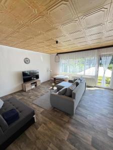 a large living room with a couch and a tv at Jarmila in Tachov