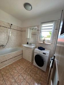 a bathroom with a washing machine and a tub at Jarmila in Tachov +9 photos
