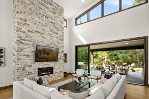 a living room with a stone wall and a fireplace at Onyx in Cle Elum