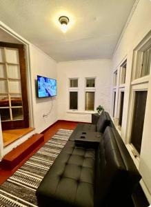 a living room with a couch and a flat screen tv at Queen Bed Shared Common Space Carrier Dome SU Hospitals in Syracuse