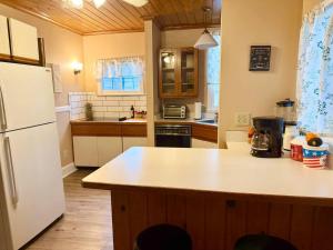 a kitchen with a white refrigerator and a counter top at Queen Bed Shared Common Space Carrier Dome SU Hospitals in Syracuse